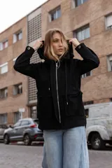 Gabardina liviana color beige con capucha, cierre frontal oculto y cintura ajustable mediante cordón. Presenta bolsillos delanteros amplios y mangas largas con puños rectos.