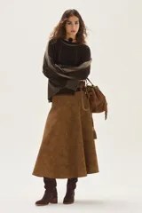 Sweater de tejido de punto en color beige, con mangas largas que presentan detalles de textura en relieve y paneles laterales en tono gris. Confeccionado en lana italiana, cuenta con puños acanalados y detalles en lurex.