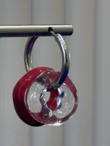 Aros tipo argolla de plata 925, con dijes circulares intercambiables en color rojo coral y vidrio transparente.