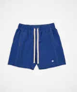Short de baño azul eléctrico con cordón de ajuste beige y costuras blancas visibles. Presenta un pequeño logo bordado en forma de asterisco en la parte inferior derecha.