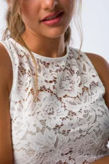Musculosa blanca de encaje con cuello redondo y sin mangas.