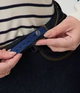 Pantalón de jean recto tiro alto con elastano, color azul oscuro, con bolsillos laterales y traseros, cierre frontal con botón y cremallera, y trabillas para cinturón.