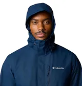 Campera impermeable Columbia modelo Hikebound II, color azul marino, con capucha ajustable, cierre frontal completo y bolsillo con cierre en el pecho. Diseño técnico con logo de la marca estampado.