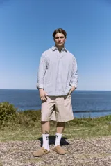 Short color beige de tiro medio con cierre de cremallera, bolsillos delanteros y traseros.