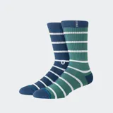 Medias de caña media Stance con diseño asimétrico a rayas horizontales en tonos azul y verde, con puntera y talón reforzados.