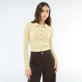 Cárdigan de punto fino color amarillo pastel, con cuello tipo polo, manga larga y cierre frontal de botones metálicos.
