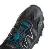 Championes de trail running Adidas Hyperturf Adventure, color negro con detalles en gris y acentos en azul petróleo. Presentan un diseño robusto con malla técnica, refuerzos sintéticos, sistema de ajuste rápido con cordón elástico y suela con tecnología Adiprene+ para mayor amortiguación.