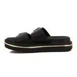 Sandalias planas negras con plataforma gruesa y dos tiras anchas ajustables con hebillas cuadradas doradas. La plataforma tiene un detalle de línea dorada.