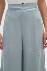Pantalon de lyocell de tiro alto y corte ancho, con diseño de pinzas frontales y costuras verticales decorativas.