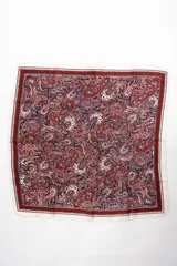 Bandana cuadrada con estampado paisley en tonos bordó, azul marino y blanco, con bordes en tono crudo y marco decorativo.