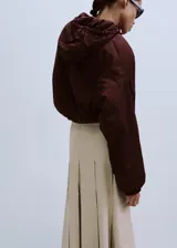 Falda midi color beige claro con diseño de tablas encontradas y corte en A.