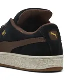 Championes Puma modelo Suede XL Wild, color negro y chocolate, confeccionados en gamuza con cordones anchos de estampado animal print, suela gruesa y detalles dorados.