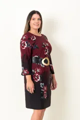 Vestido corto en jersey estampado color bordó con flores rojas y grises, de corte suelto con mangas 3/4 acampanadas y cuello redondo. Incluye cinturón ancho de cuero sintético negro con hebilla circular. 