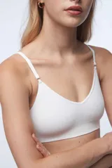 Sostén tipo bralette color beige, de tela acanalada, con breteles ajustables, doble tela y espalda con broche de tres medidas. Sin relleno ni aro.