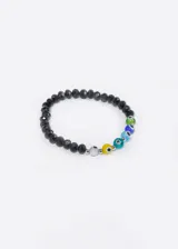 Pulsera elástica con mostacillas facetadas negras y mostacillas de colores con diseño de ojo turco.