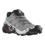 Championes Salomon Speedcross 6 de color negro, diseñados específicamente para trail running. Presentan una estructura robusta y técnica, capellada sintética y textil con refuerzos termosellados, sistema de cordones de ajuste rápido Quicklace y suela con tacos profundos para máxima tracción en terrenos difíciles.