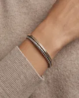 Esclava rígida de plata 925 con diseño trenzado y detalle de lámina de oro de 18k en la parte superior.
