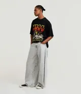 Remera negra de algodón con corte boxy y cuello redondo. Presenta un estampado grande en la espalda con un collage de imágenes de la banda Kiss, incluyendo el texto "UNMASKED".