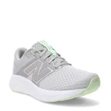 Championes New Balance modelo 460, color gris con detalles en verde claro. Presentan un exterior de malla transpirable con refuerzos sintéticos, cierre con cordones y entresuela blanca amortiguada.