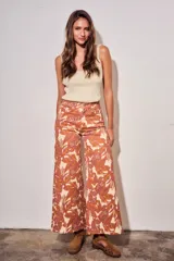 Jean wide leg de tiro medio, con estampado botánico en tonos terracota y beige, confeccionado en denim de algodón con elastano.