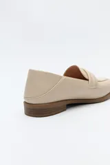 Mocasín negro de cuero sintético con punta cuadrada, detalle de textura en la capellada y taco bajo de 2,5 cm.