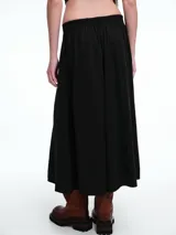 Falda larga de silueta amplia y caída fluida, con cintura limpia en el frente y elástico en la parte posterior.