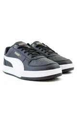 Championes Puma Caven 2.0 de estilo urbano, color negro con detalles en blanco y logotipos dorados.