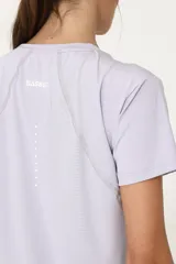 Remera deportiva lila de poliéster y elastano, con recortes laterales y traseros.