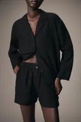 Shorts de tiro medio confeccionados en lino, con cintura elástica y bolsillos laterales ocultos en costura.
