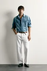 Jeans relaxed fit color blanco, de corte recto y tiro medio con tejido de algodón rígido. Cuenta con cinco bolsillos, efecto ligeramente lavado, perneras con raya de planchado y cierre frontal con cremallera y botón.