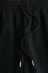 Pantalón de jogging negro de tiro alto en felpa de mezcla de algodón, con cordón ajustable en la cintura y elástico en cintura y bajos.