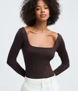 Body de manga larga confeccionado en microfibra de poliamida con elastano. Presenta un diseño ajustado al cuerpo con escote cuadrado y cierre inferior mediante botones de presión.