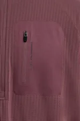 Sudadera técnica color vino tinto, de manga larga, con cuello subido y cierre frontal de cremallera. Presenta un bolsillo frontal con cierre de cremallera oculta en costura y detalle de logo estampado. El tejido tiene estructura waffle en el interior.