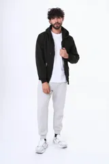 Buzo con cierre completo y capucha, confeccionado en felpa con friza. Presenta un diseño básico con bolsillos frontales tipo canguro y puños elásticos.