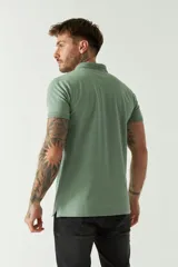 Remera polo blanca de manga corta, con cuello clásico, cierre de tres botones y logo estampado en el pecho.