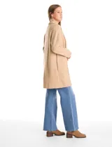 Cardigan largo de tejido de punto suave, color gris, con cuello con caída fluida, mangas largas con hombros caídos y bolsillos laterales discretos.