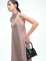 Vestido largo de breteles finos con escote en V, confeccionado en lyocell con acabado efecto lavado. Presenta una silueta levemente evasé con caída fluida y recta.