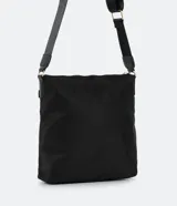Bolso tipo bandolera modelo postman, color negro, confeccionado en tejido de poliéster. Cuenta con correa ajustable de cinta de gross, cierre principal por cremallera y dos bolsillos delanteros con cierre metálico.