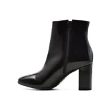 Bota corta de charol negro con punta redondeada y taco cuadrado.