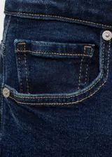 Jeans de corte flare y tiro alto, color azul oscuro, con diseño crop y terminación deshilachada en los tobillos. Cuenta con cierre de cremallera y botón, trabillas para cinturón y cinco bolsillos.