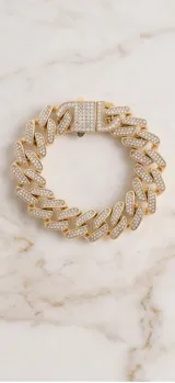 Pulsera tipo eslabón cubano de acero con baño de oro y engarzado de circonias en micropavé.