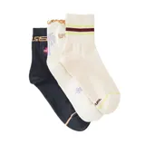 Pack de tres pares de medias de corte medio con diseños variados, incluyendo una negra con detalles geométricos y florales, una blanca con ribete ondulado y estampado de palmeras, y una blanca con franjas deportivas en la caña.