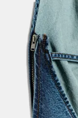 Mono de denim de pierna ancha con cuello halter fluido y espalda descubierta. Incluye cinturón del mismo tejido para ajustar en la cintura, bolsillos delanteros y cierre lateral con cremallera.