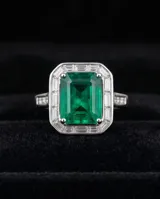 Anillo de plata 925 con piedra central rectangular verde de raíz de esmeralda, rodeada de circonias.