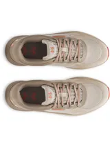 Championes de trail running Under Armour Charged Bandit TR 3, color beige con detalles en naranja. Presentan una parte superior de malla transpirable con refuerzos estratégicos, entresuela Charged Cushioning para mayor amortiguación y suela exterior con tacos técnicos para tracción en senderos.