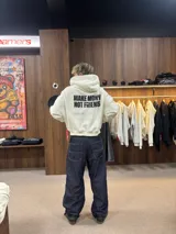 Hoodie de color blanco con capucha, corte holgado y estampado gráfico en la espalda con la frase 'MAKE MONEY NOT FRIENDS' en color negro.