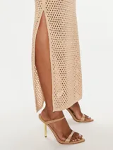 Vestido largo negro calado de malla con lunares brillantes, cuello halter, cortes en los laterales, aberturas laterales y forro.