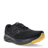Championes de running New Balance Evoz V4, con capellada de malla técnica negra y entresuela Fresh Foam X. Presenta el logo N en los laterales y suela de goma en color amarillo.