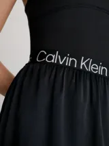 Vestido negro de punto acanalado elástico en la parte superior con escote cuadrado y espalda de nadador. La falda es de crepé tejido con vuelo y la cintura elástica lleva el logo repetido de Calvin Klein Jeans.