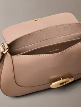 Cartera mediana de poliuretano color tostado, con diseño estructurado, solapa frontal, cierre de broche a presión metálico dorado con el logo de Calvin Klein y correa ajustable.